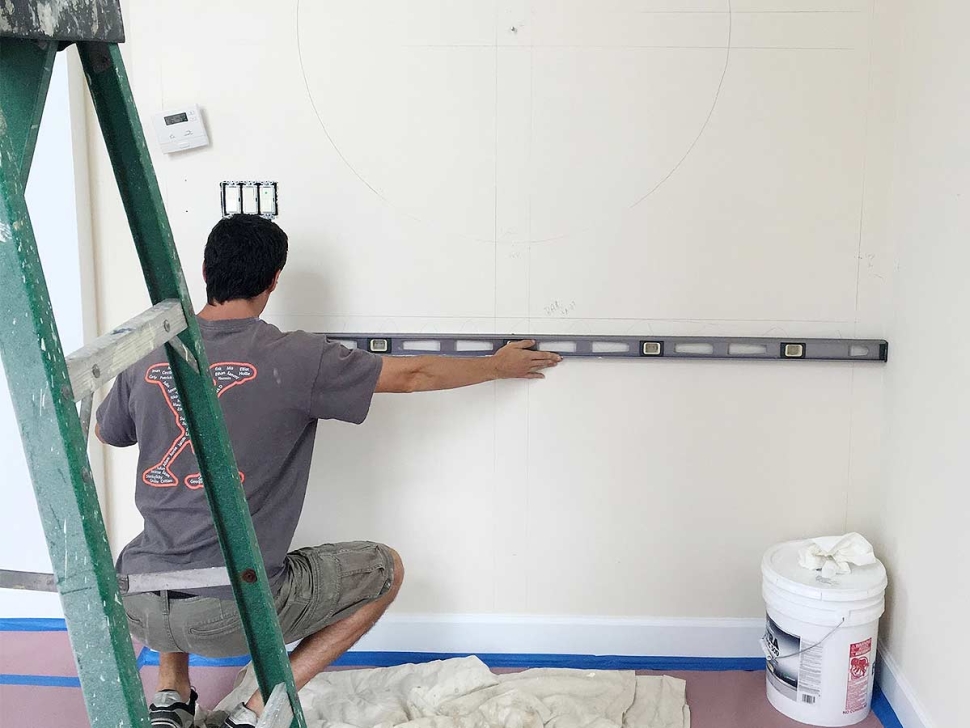 Carpenter measuring for a wall mirror